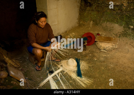 Woman braiding the famous panama straw hats in a traditional cave in Becal Mexico Stock Photo