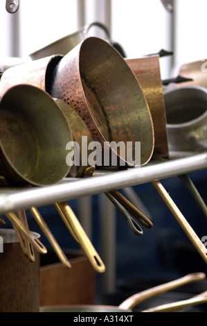 Royalty free photograph of copper pots and pans in British commercial restaurant kitchen London UK Stock Photo