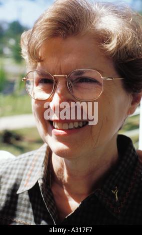 A smiling woman wearing glasses resides in Defuniak Springs Florida, a small town in the panhandle. Betty Martin, model released Stock Photo