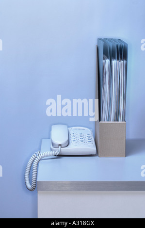 telephone and files on tidy desk in office Stock Photo