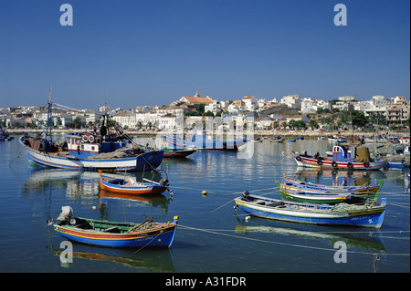 Portugal the Algarve Lagos town seen over the fishing boats in harbour Stock Photo