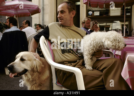 luxembourg on foot man with dogs at cafe luxembourg city 1995 Stock Photo