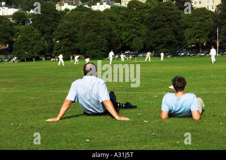 Two men watching village cricket Portishead Bristol Avon England Stock Photo