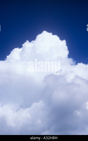 White and grey cumulus storm clouds gathering against clear blue sky Stock Photo