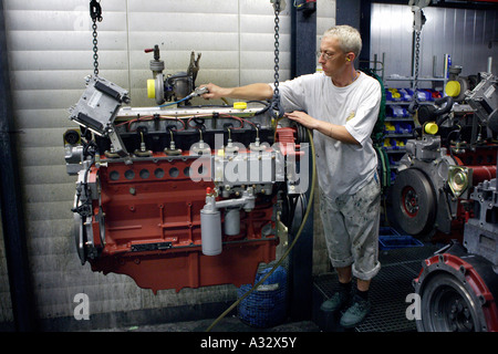 Mechanic working on an engine at the car factory Deutz AG in Cologne Porz, Germany Stock Photo