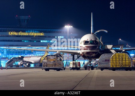 A DHL cargo plane at the Cologne Bonn Airport at night, Germany Stock Photo