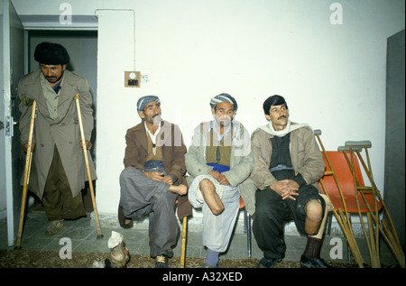 Iraq Kurdistan: Farmers who have lost limbs to land-mines attend a prosthesis clinic. Stock Photo