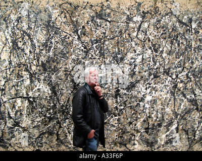 A visitor to MOMA the museum of modern art in Manhattan New York ponders Jackson Pollock painting One: Number 31, 1950. Stock Photo