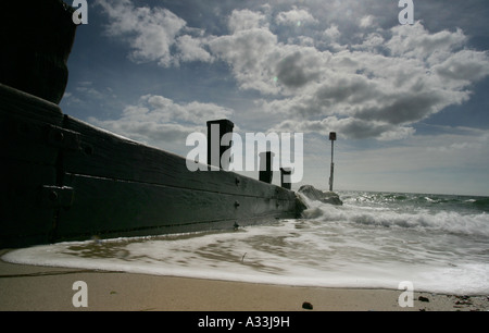 sea washes up against the sea groyne defences at avon beach Stock Photo