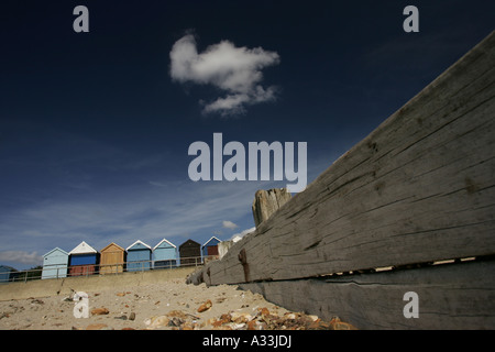 a polarized avon beach landscape near christchurch hampshire  with beach huts and dark blue sky with one fluffy cloud Stock Photo