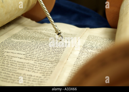 Hebrew Torah scroll with silver yad pointing to Hebrew words Stock Photo