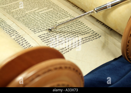 Hebrew Torah scroll with silver yad pointing to Hebrew script Stock ...