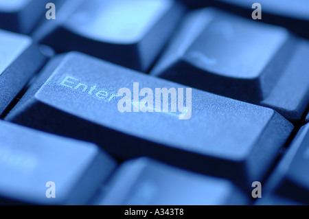 computer keyboard under blue light, enter key Stock Photo