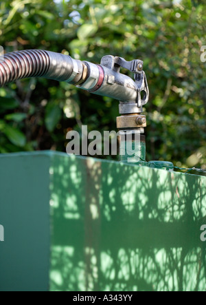 Household heating oil tank being filled by pump Stock Photo