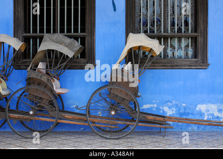 Wooden rickshaws on the exterior of Cheong Fatt Tze Mansion, Georgetown, Penang, Malaysia Stock Photo