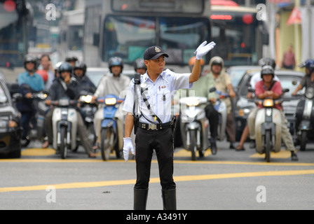 Policeman directing traffic during rush hour, Kuala Lumpur, Malaysia Stock Photo