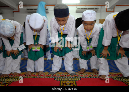 Primary level one and kindergarten students during prayer time at a mosque, Kuala Lumpur, Malaysia Stock Photo