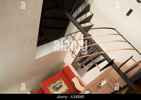 Modern European interior red and white stucco wall with iron stairs Stock Photo
