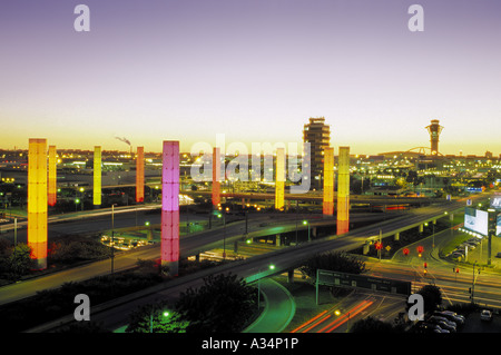 Colorful illuminated pylons form a decorative sight where Century Boulevard reaches Los Angeles International Airport, LAX Stock Photo