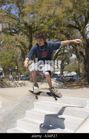 Skateboarder jumps over steps in mid air at Ocala Skate Park in Florida USA Stock Photo