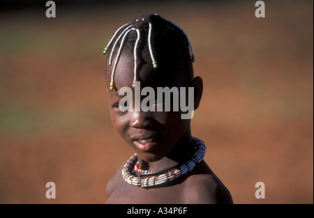 Boy with beaded hairbraids and beaded necklace Himba or Ovahimba tribe Kaokoveld Namibia Africa Stock Photo