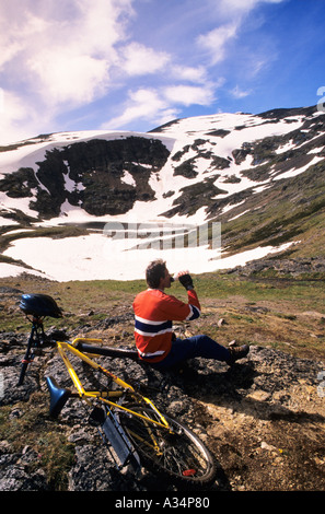 Mountain biker taking drink Crater Lake area Hudson Bay mountain Smithers British Columbia Canada Stock Photo