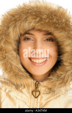 Portrait of young woman wearing fur hood Stock Photo