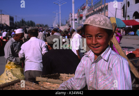 Uighur boy at the Kashgar Sunday Market Xinjiang Province China Stock Photo