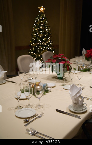White linen and stemware on table set for guests in conference room Stock Photo