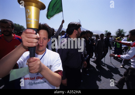 A mental disabled athlete holding the Olympic's torch during the Special Olympics Afghanistan opening day in Kabul. Stock Photo