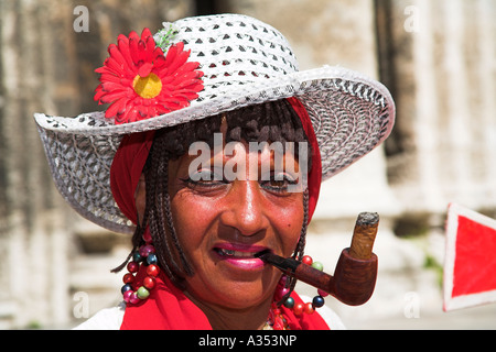 Colourful lady smoking a pipe and cigar, Plaza de la Catedral, Havana, La Habana Vieja, Cuba Stock Photo