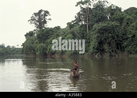 A Ukre Village Brazil Kayapo man paddling a dugout canoe in the early morning Stock Photo
