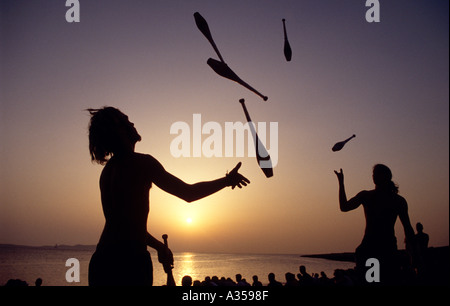 Juggling at sunset at the Cafe del Mar in San Antonio, Ibiza, Spain Stock Photo