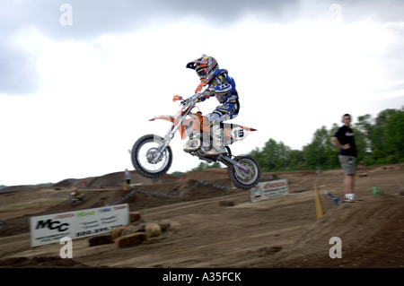 Motocross racing 8 year Justin Cooper races in the 7 8 year Peewee MX class on a  KTM SSX 50 cc bike. Stock Photo