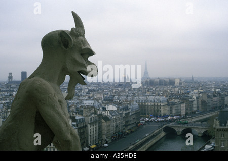 One of the many gargoyles atop Notre Dame Cathedral looking out over the city of Paris prior to the devastating April 15, 2019 fire. Stock Photo