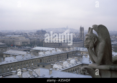 One of the many gargoyles atop Notre Dame Cathedral looking out over the city of Paris prior to the devastating April 15, 2019 fire. Stock Photo