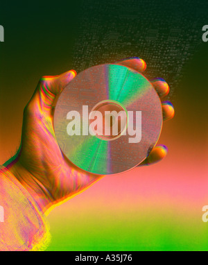 Compact disc CD and hand Stock Photo