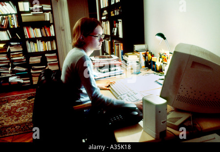 Paris, France, Young Adult Woman, Working Late on Computer working from home Office, Busy Desk Stock Photo