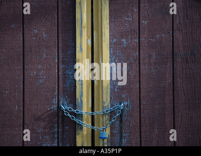 Lock and chain on a barn door Stock Photo