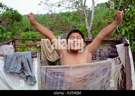 A Shipibo boy prepares for a shower in the village of San Francisco on the Yarinacocha. Near Pucallpa Ucayali Peru South America Stock Photo