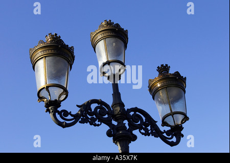 old gas street lamps now electric lights on bridge over the liffey in O Connell street Dublin Stock Photo