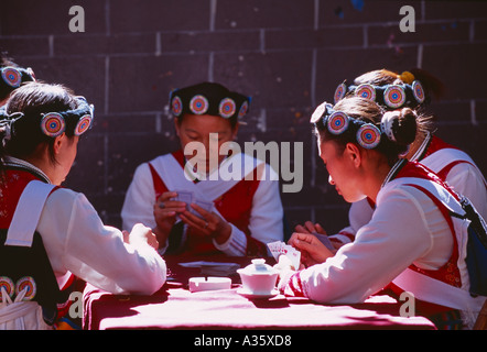 local Naxi women playing cards Lijiang Yunnan Province China Stock Photo