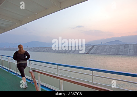 CHINA YANGTZE RIVER SANDOUPING Tourist jogs on deck at sunset as Chinese Cruise ship travels up the Yangtze River Stock Photo