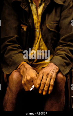 detail tumeric seller holding a cigarette in his yellow stained hands Kathmandu Nepal Stock Photo