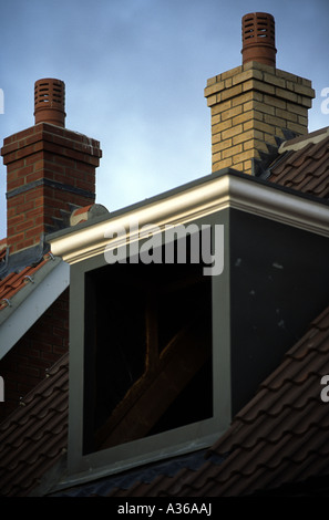 Fibreglass dormer window and plastic replica chimneys on a newly constructed house in Kesgrave near Ipswich, Suffolk, UK. Stock Photo