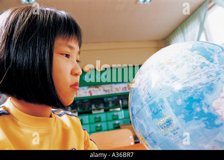 A girl is seeing a globe Stock Photo