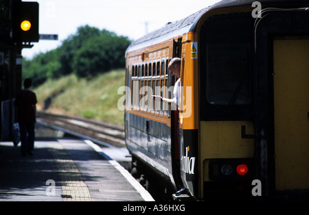 Local passenger train being held by a signal at Westerfield station due to late running freight train from Felixstowe docks. Stock Photo