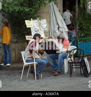 Street artist painting a portrait Havana Cuba Stock Photo