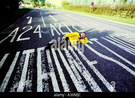 Dutch author Pieter Boogaart lies on the A272 at its junction with the A24 at Dragons Green near Billingshurst West Sussex Stock Photo