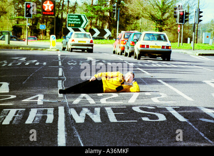 Dutch author Pieter Boogaart lies on the A272 at its junction with the A24 at Dragons Green near Billingshurst West Sussex Stock Photo